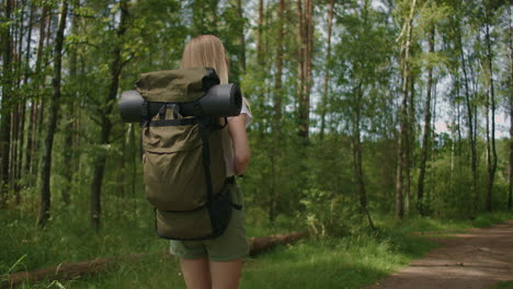 Slow-motion:-Traveling-Happy-woman-with-backpack-walking-on-path-the-tropical-forest